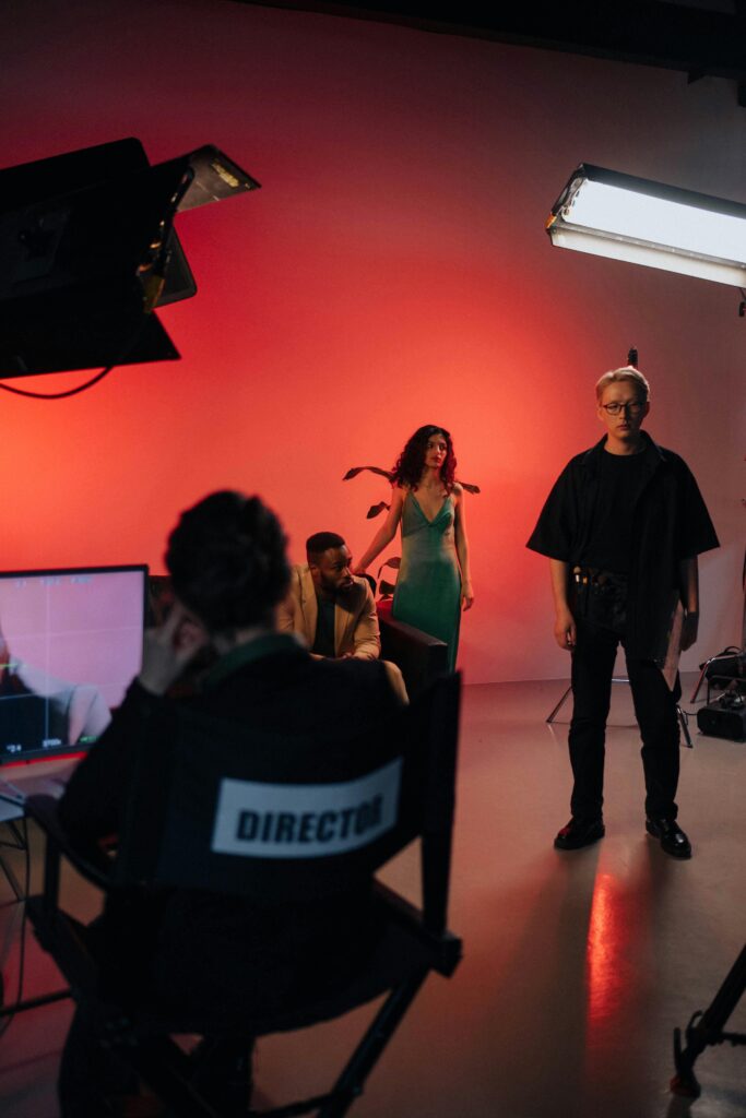 rezyser Behind the scenes view of a dynamic film studio set with a director and crew in action.