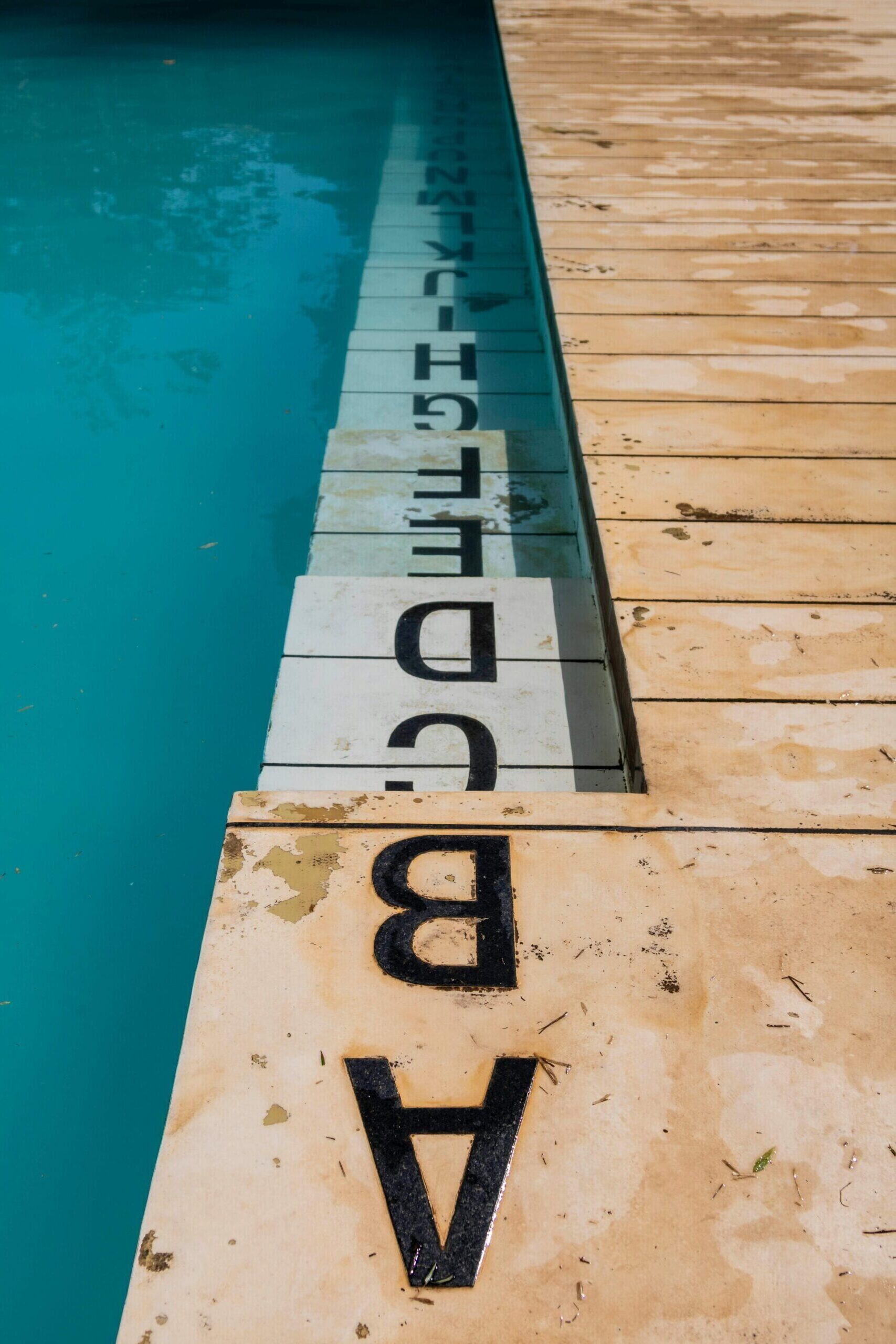 Creative alphabet tiles form unique poolside design in MG, Brazil. Ideal for decor concepts.