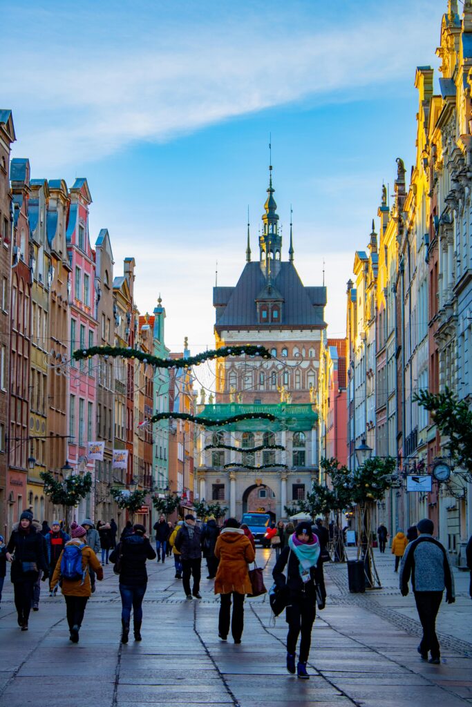 Vibrant street view of Gdansk with people exploring the colorful architecture and historic buildings.